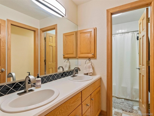 bathroom with double vanity, a shower with curtain, and a sink