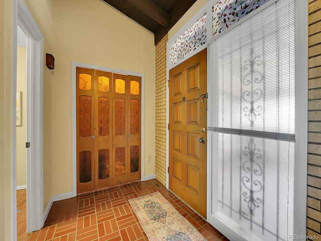 foyer featuring beam ceiling