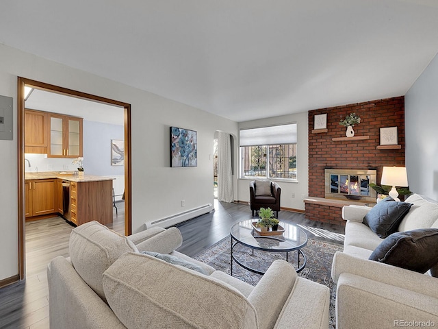 living room with a brick fireplace, a baseboard radiator, and wood-type flooring