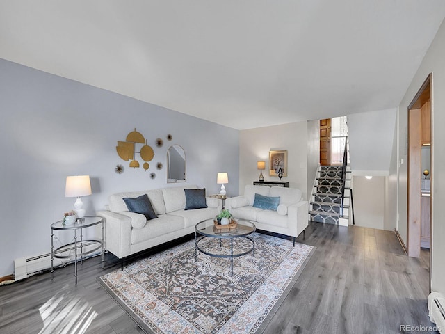 living room featuring wood-type flooring and baseboard heating