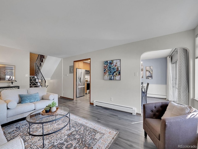 living room featuring hardwood / wood-style flooring and a baseboard heating unit