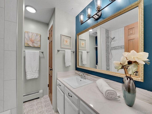 bathroom featuring a baseboard radiator, vanity, and a tile shower