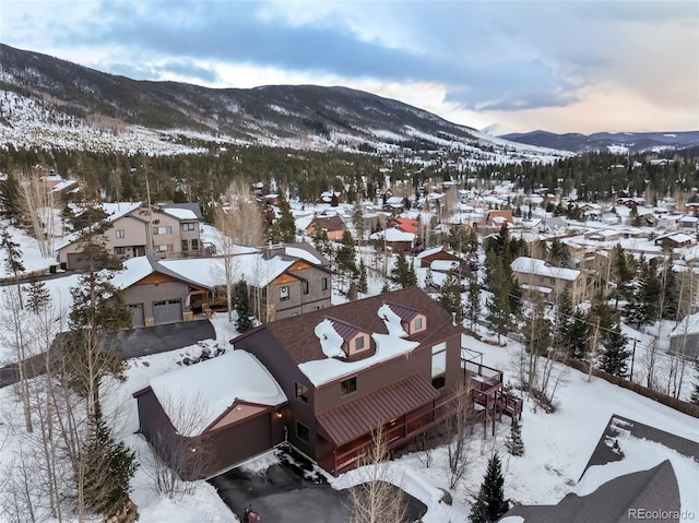 snowy aerial view featuring a residential view and a mountain view