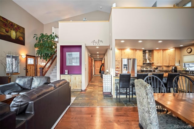 living area with stairway, recessed lighting, dark wood-style floors, and high vaulted ceiling