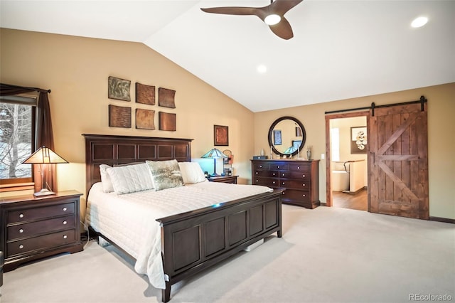 bedroom featuring ensuite bath, lofted ceiling, ceiling fan, a barn door, and light colored carpet