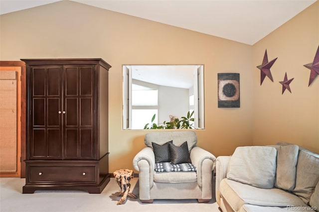 living area featuring lofted ceiling and carpet floors