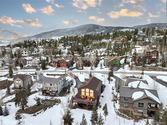 snowy aerial view with a residential view and a mountain view