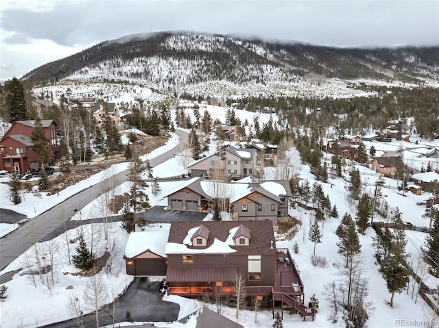 snowy aerial view with a mountain view