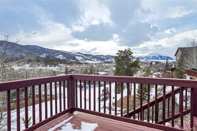 snow covered deck featuring a mountain view