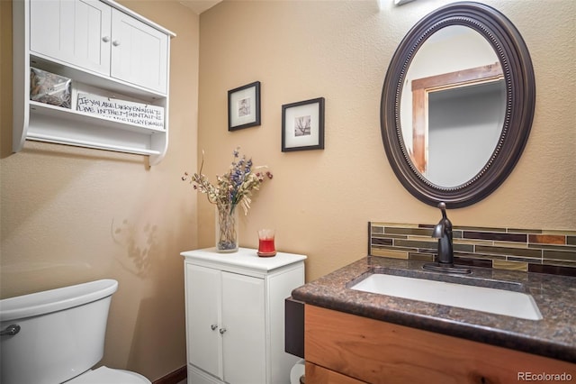 bathroom with toilet and vanity