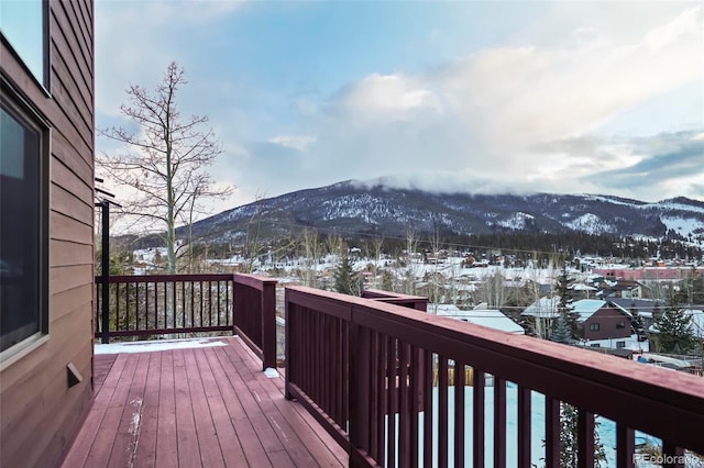 snow covered deck featuring a mountain view