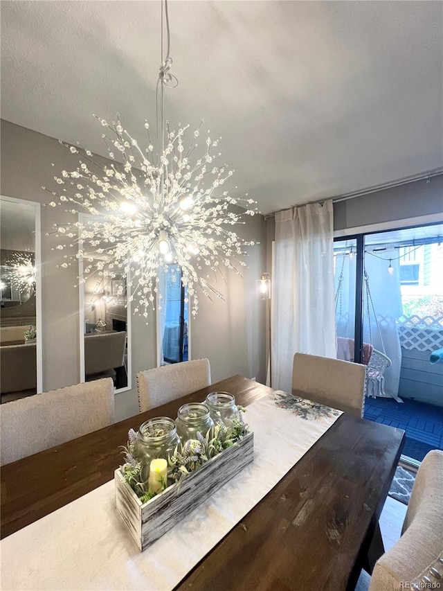 dining area with wood-type flooring and a chandelier