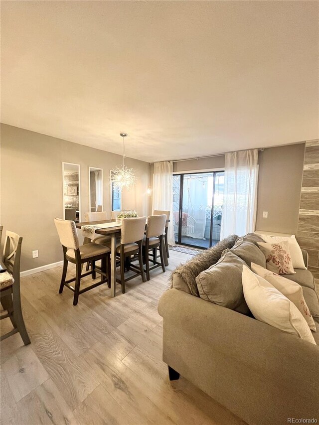 living room featuring light hardwood / wood-style flooring and a chandelier