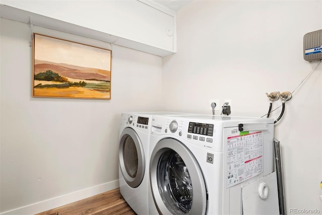 1805 W 51st Ave, Denver, CO 80221 - washroom featuring washing machine and clothes dryer, laundry area, baseboards, and wood finished floors
