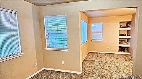 unfurnished room with baseboards