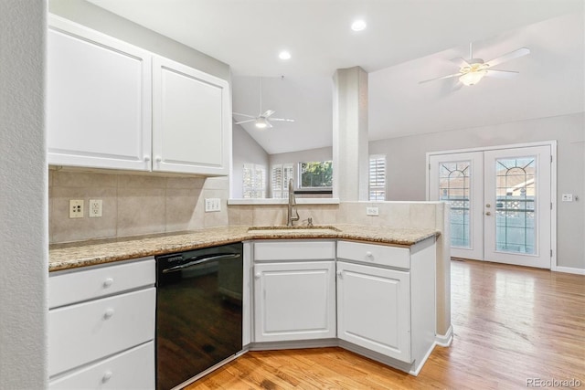 kitchen featuring french doors, white cabinets, vaulted ceiling, sink, and dishwasher