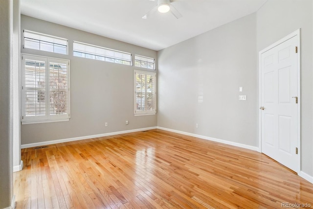 empty room with hardwood / wood-style flooring and ceiling fan