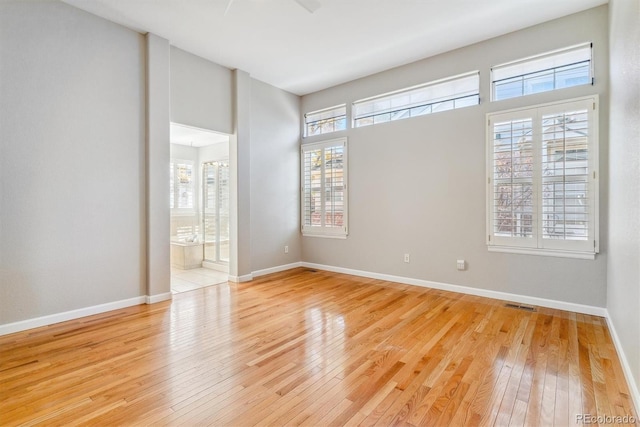 spare room with plenty of natural light and light wood-type flooring