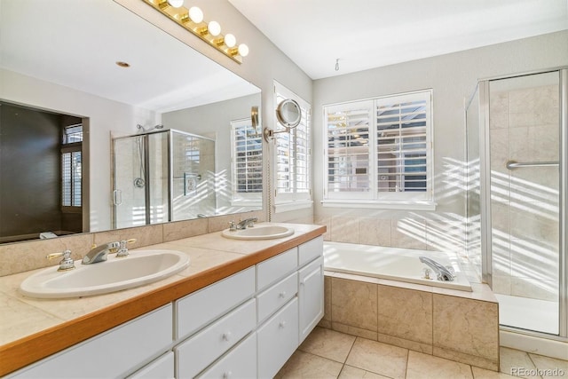 bathroom with tile patterned floors, a wealth of natural light, and independent shower and bath