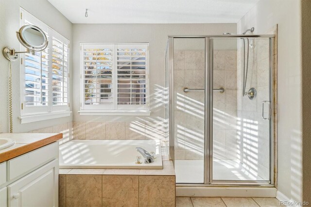 bathroom featuring tile patterned floors, vanity, a healthy amount of sunlight, and shower with separate bathtub