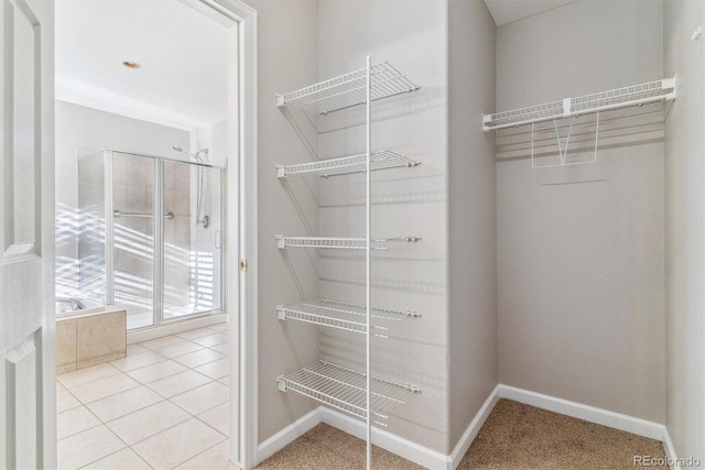 walk in closet with light tile patterned flooring