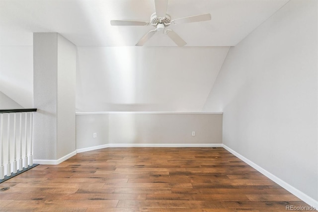 spare room with lofted ceiling, ceiling fan, and dark hardwood / wood-style floors