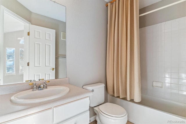 full bathroom with vanity, toilet, and shower / bath combo with shower curtain