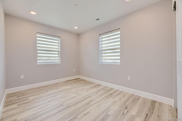 spare room featuring light hardwood / wood-style flooring