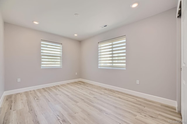 unfurnished room with light hardwood / wood-style flooring and a wealth of natural light