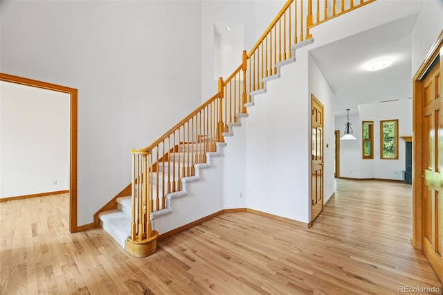 5284 Taft Ct, Arvada, CO 80002 - staircase featuring wood finished floors and a towering ceiling