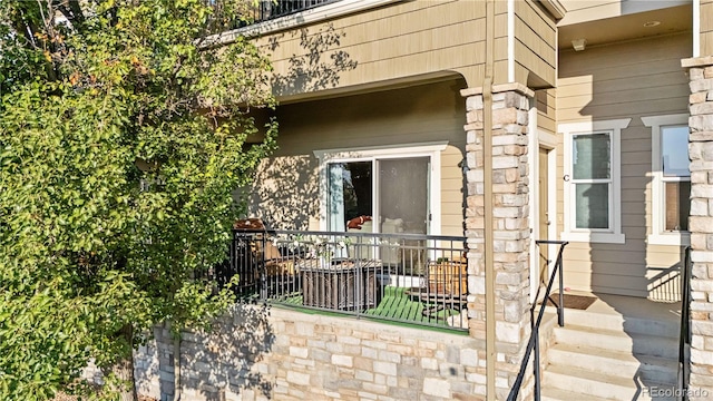 view of exterior entry featuring stone siding