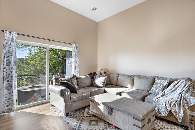 living area featuring visible vents and wood finished floors