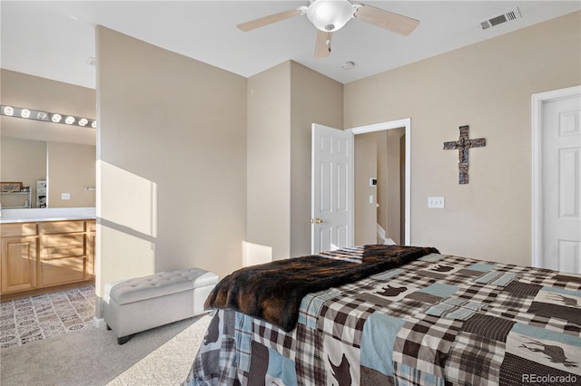 bedroom with visible vents, a ceiling fan, and light colored carpet