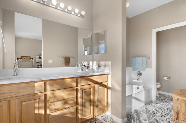 full bath featuring a washtub, a sink, toilet, and double vanity