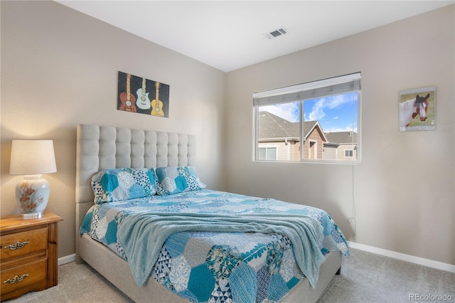 carpeted bedroom featuring visible vents and baseboards