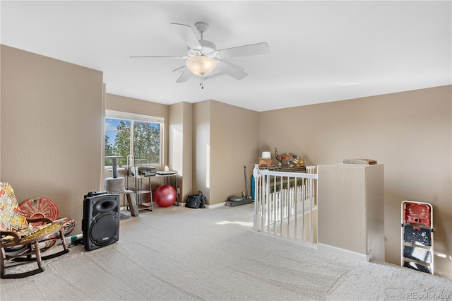 rec room with a ceiling fan, carpet, and baseboards