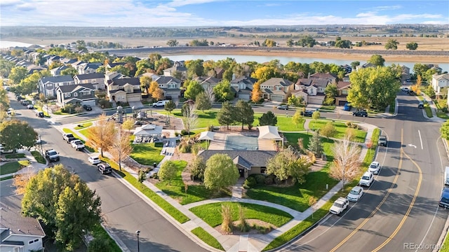 drone / aerial view featuring a residential view and a water view