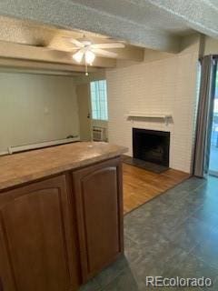 interior space with ceiling fan, beam ceiling, and a textured ceiling