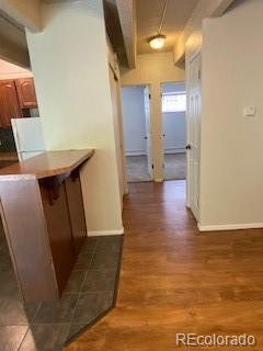 hallway with hardwood / wood-style floors