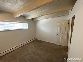 interior space featuring dark carpet, a textured ceiling, and baseboard heating