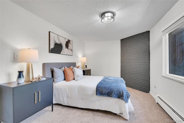 bedroom featuring a baseboard heating unit, a textured ceiling, and carpet floors