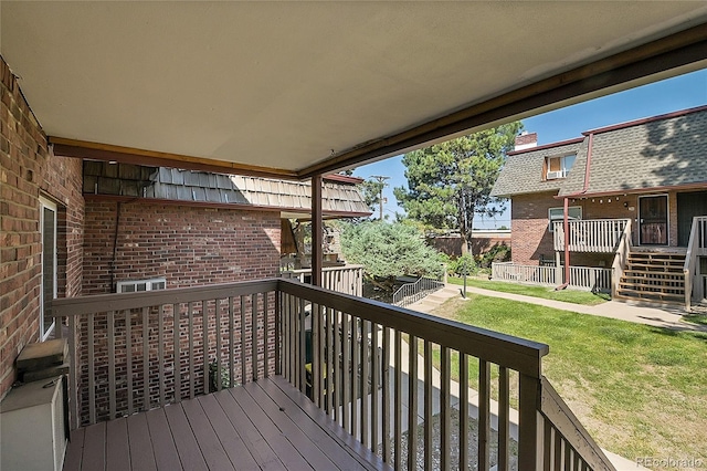 wooden terrace with a lawn