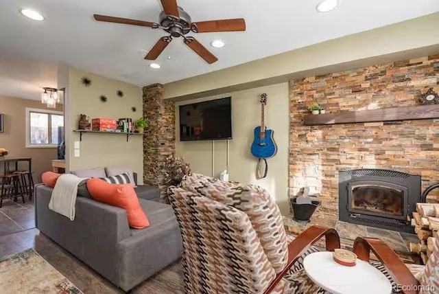 living room with a fireplace and ceiling fan