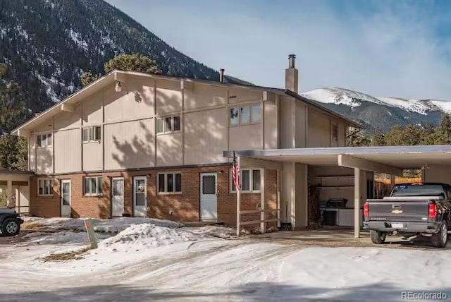 exterior space with a carport and a mountain view