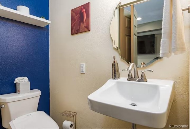 bathroom featuring toilet and sink