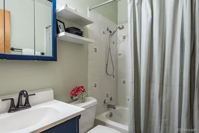 full bathroom with vanity, toilet, and shower / bath combo with shower curtain