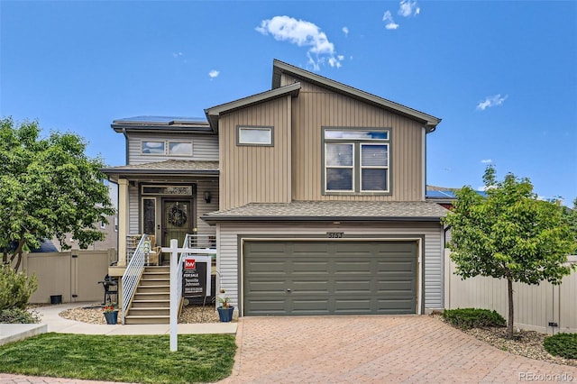 5153 Andes Way, Denver, CO 80249 - view of front of house with an attached garage, decorative driveway, and roof with shingles