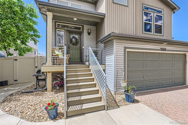 5153 Andes Way, Denver, CO 80249 - property entrance featuring a garage and decorative driveway