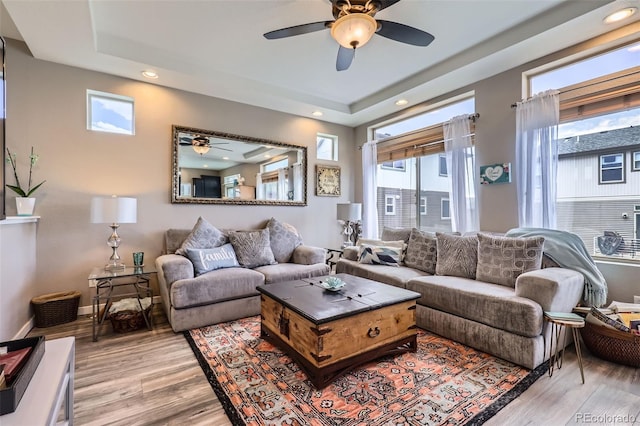 5153 Andes Way, Denver, CO 80249 - living area featuring a ceiling fan, light wood-type flooring, a tray ceiling, and recessed lighting