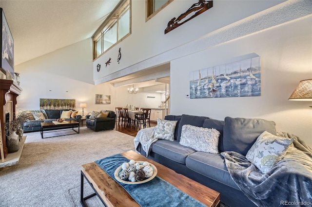 living room featuring high vaulted ceiling, carpet, and an inviting chandelier